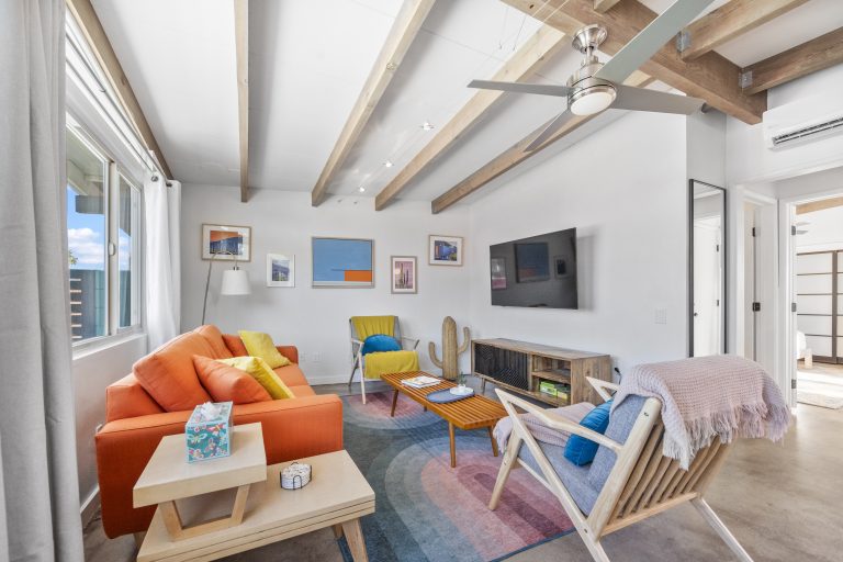Mid-century house living room with beamed ceiling and colorful decor