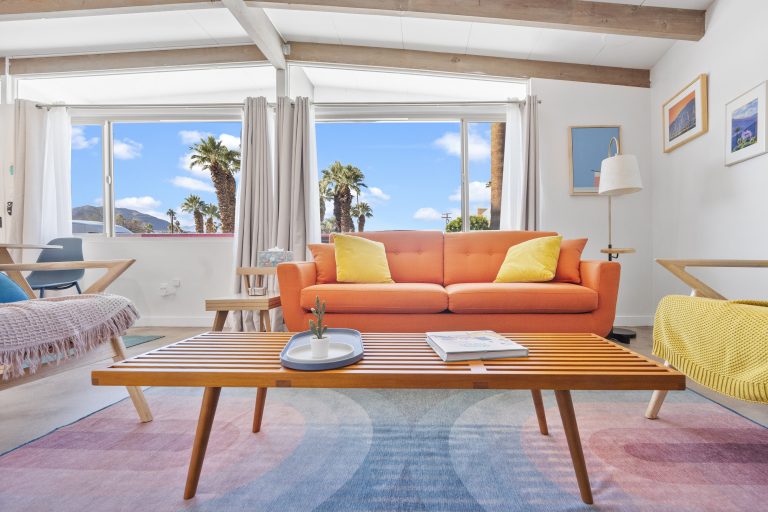 Mid-century house living room with orange sofa and retro coffee table