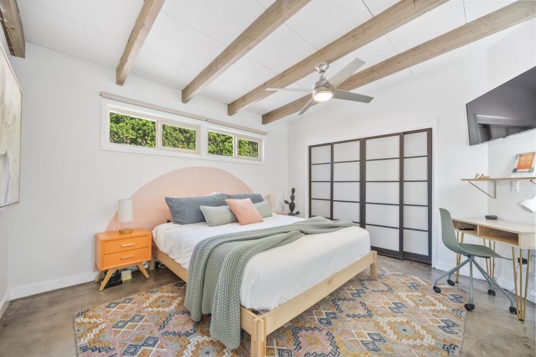 Mid-century house bedroom with beamed ceiling and desk