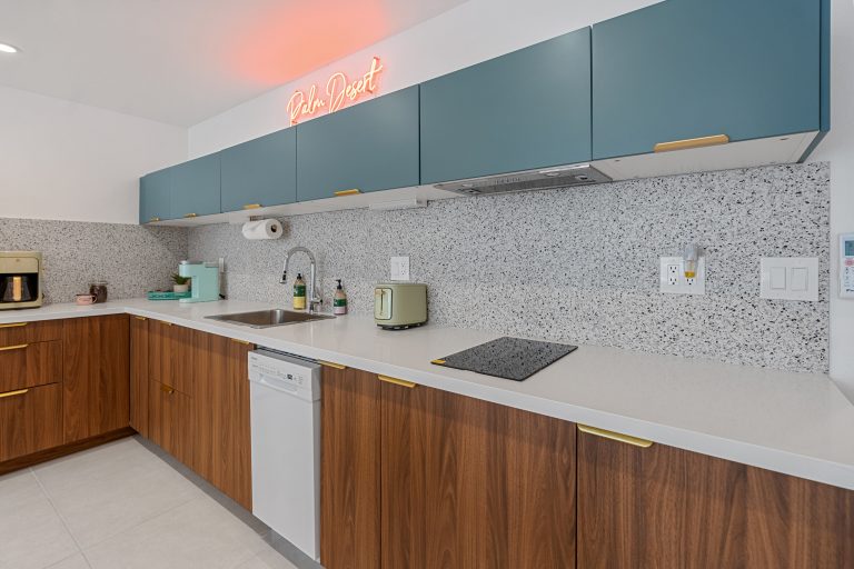 Blue Condo kitchen with teal cabinets and wood lower cabinets