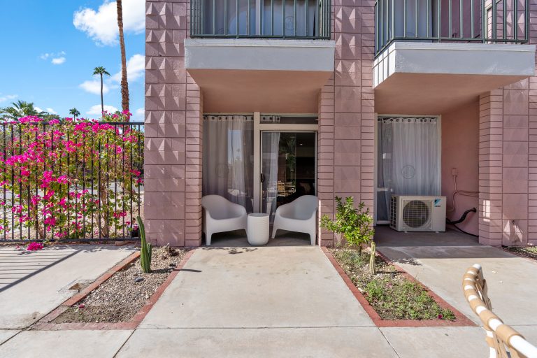 Condo entrance with pink building and bougainvillea