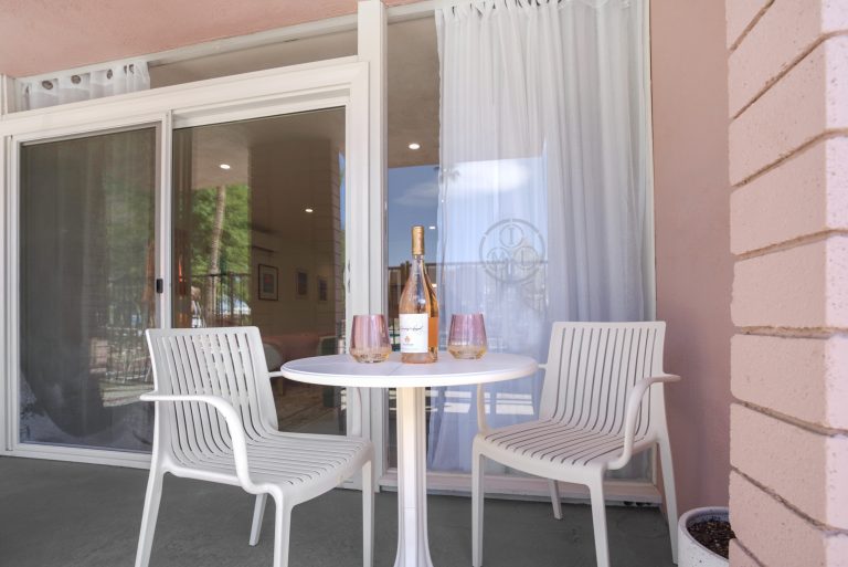 Pink Condo private patio with bistro table and chairs