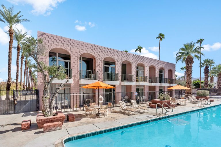 Heated pool and pink mid-century condo building in Palm Desert