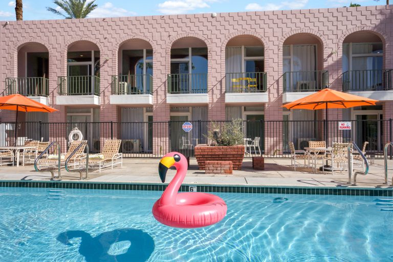 Pink Condo poolside patio with flamingo floatie
