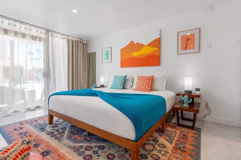 Blue condo king bed by the patio door