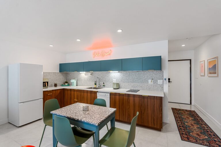 Blue condo full kitchen with dining table