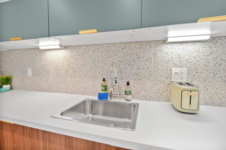 Blue condo kitchen sink and quartz counters