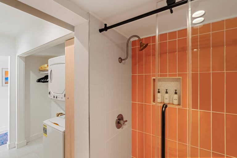 Blue condo orange tiled shower