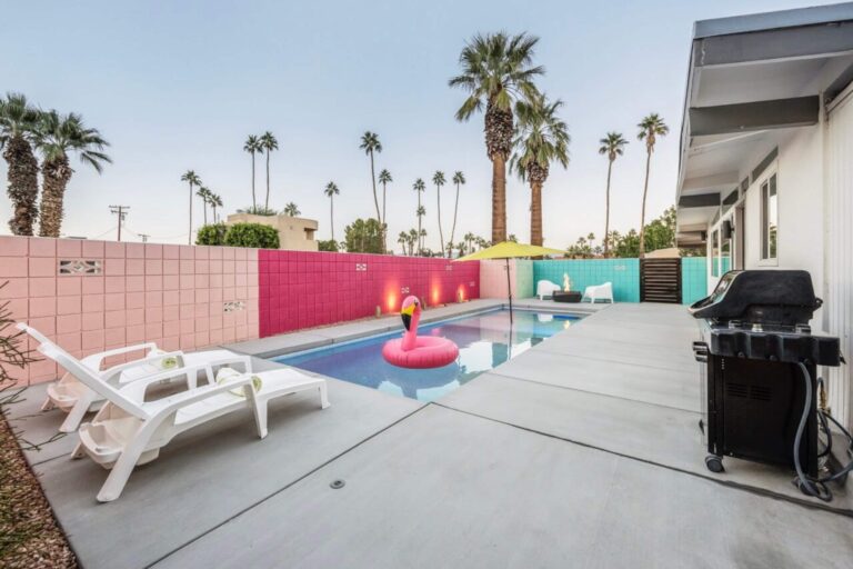 House pool with lounge chairs and grill