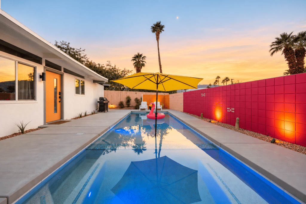 Long saltwater pool and yellow umbrella at the Palm Desert mid-century house