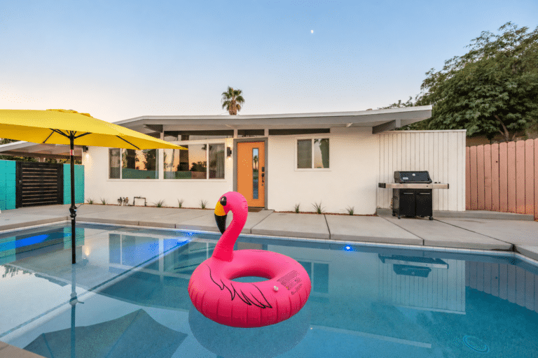 Pink flamingo float with the mid-century house and new orange front door