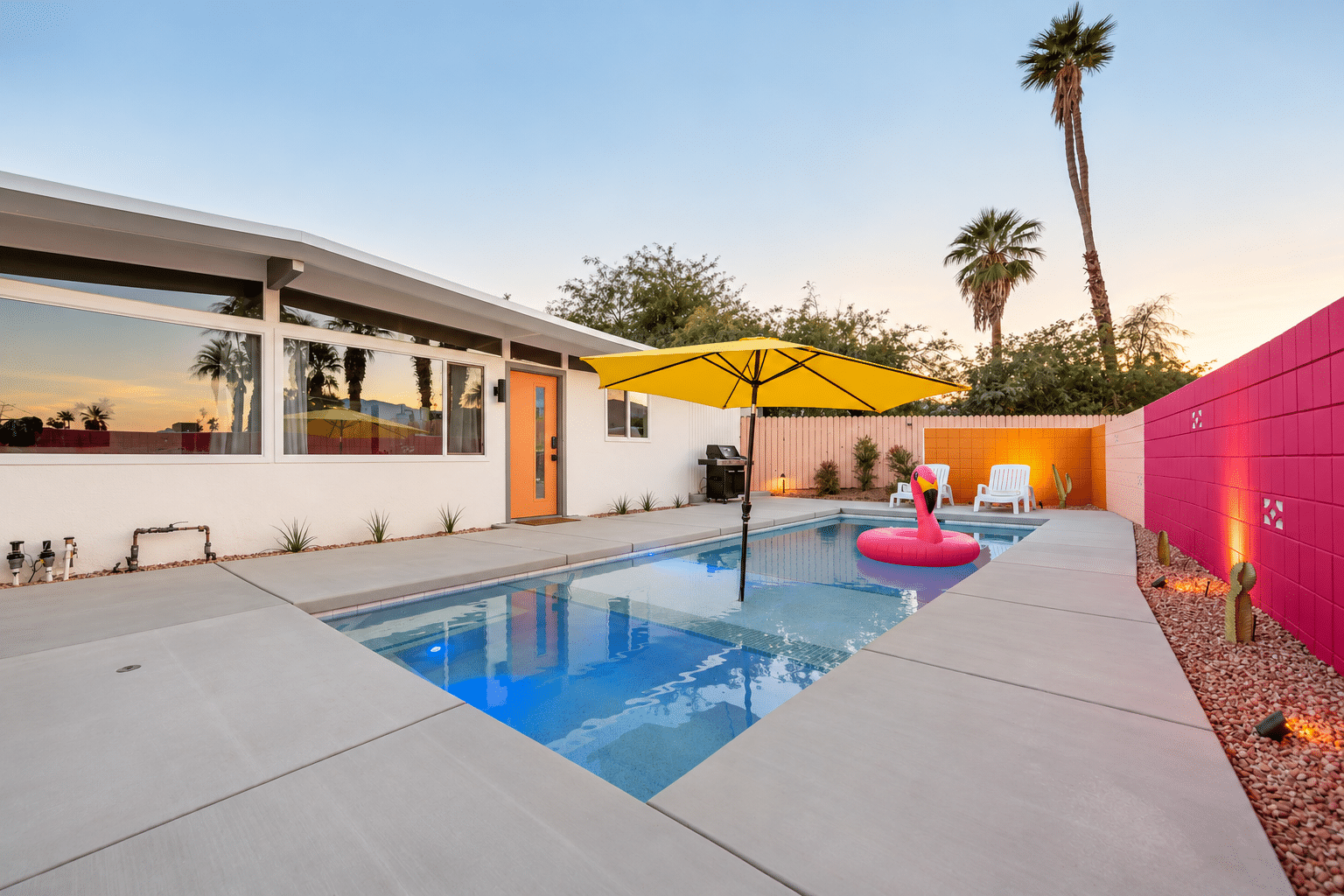 Mid-century pool home in Palm Desert with saltwater pool, yellow umbrella and pink block wall