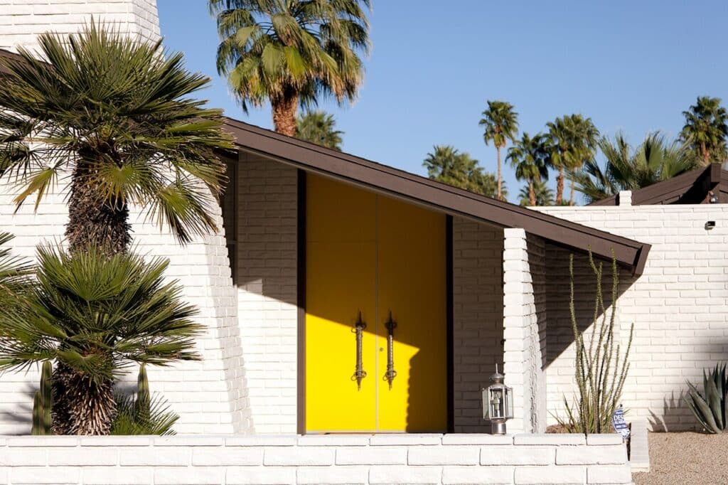 Mid century modern house with a yellow door in Palm Springs