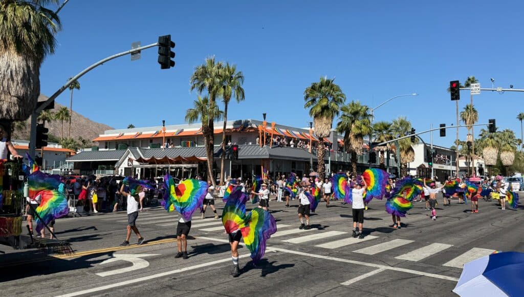 Flag spinners marching in the Palm Springs Pride Parade