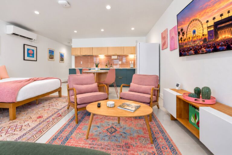 Pink condo living area and queen beds