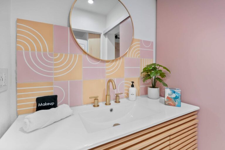Pink condo bathroom vanity with designer tile