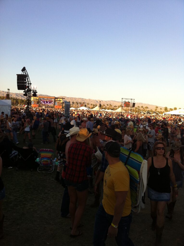 Crowd at the Stagecoach country music festival in Indio with the desert mountains behind the stage