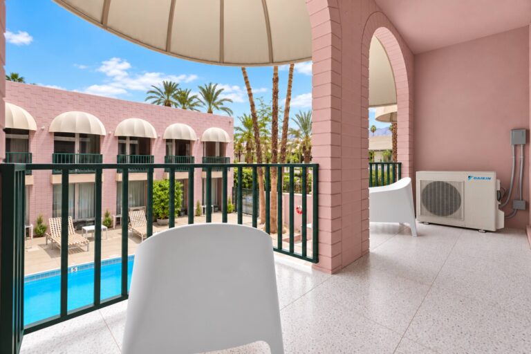 Yellow condo balcony overlooking the pool