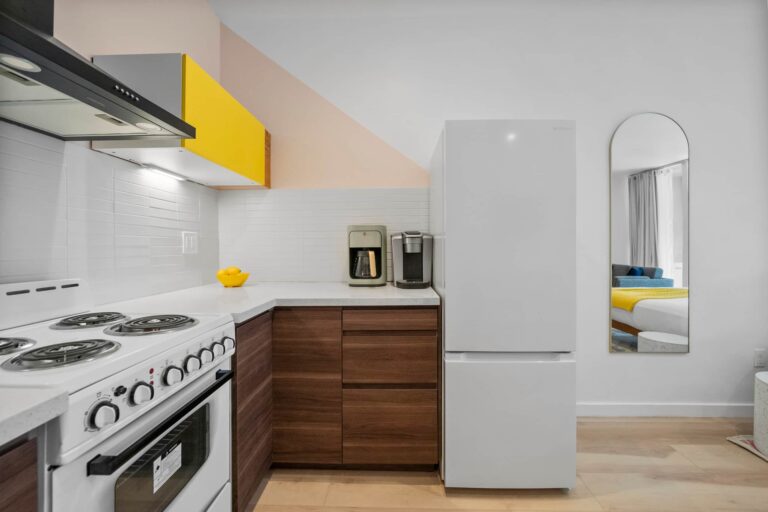 Yellow condo kitchen with full-size fridge