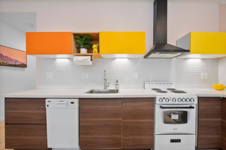 Yellow condo kitchen with stove and range hood