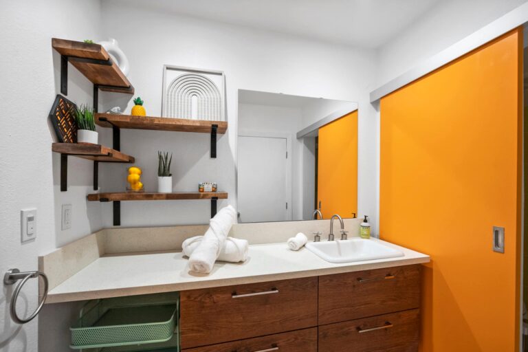Yellow condo vanity with open shelves